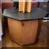 F23. Octagonal Mid Century table with cabinet door. 20.5”h x 26”w x 26”d 